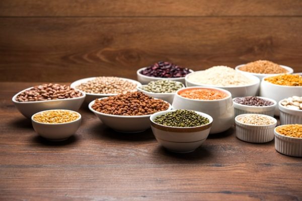 [freepicdownloader.com]-uncooked-indian-pulses-grains-seeds-white-bowls-wooden-surface-selective-focus-normal